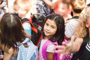 Schoolgirl In Line With Her Classmates
