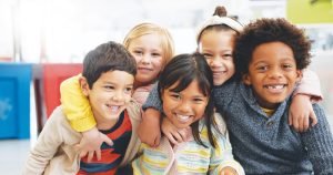 Diverse group of kids at school smiling for the camera