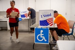 ARLINGTON, VIRGINIA - SEPTEMBER 20: People vote on the first day of Virginia's in-person early voting at Long Bridge Park Aquatics and Fitness Center on September 20, 2024 in Arlington, Virginia. Ballots have started being cast for the presidential race and local elections in Virginia, Minnesota and South Dakota. 
