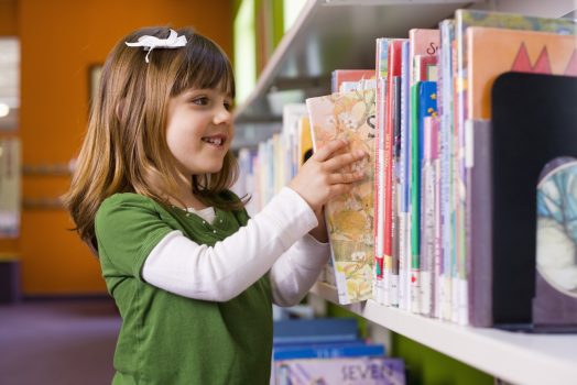 Girl looking for library book