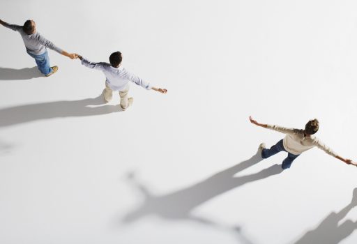 Two pairs of people holding hands, gap between pairs, overhead view Two pairs of people holding hands, gap between pairs, overhead view