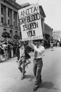An activist carries a placard which reads 'Anita: Gay Blood Is Upon You! Who's Next?' during the fifth 'Gay Freedom Day' (San Francisco Pride) during which many protesters ridiculed singer Anita Bryant and her anti gay crusade, San Francisco, California, US, 26th June 1977.