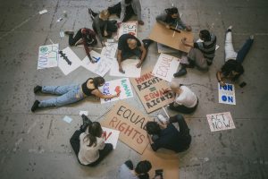 Directly above of male and female protestor preparing posters for social movement