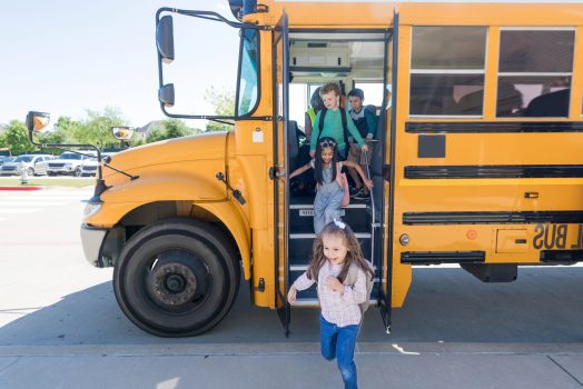 School children exit school bus A group of elementary school children exit bus at the end of the school day.