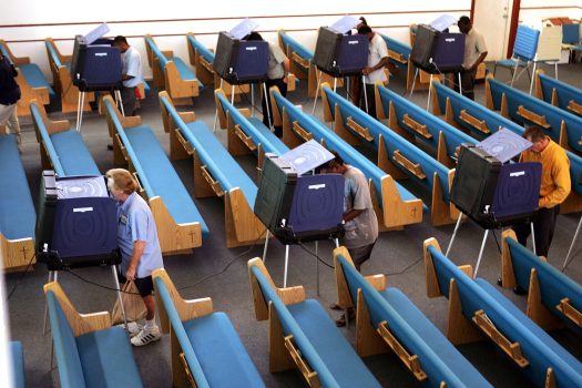 MIAMI - NOVEMBER 2:  Voters cast their votes in a church that has been setup as a polling station during the U.S. Presidential election on Election Day November 2, 2004 in Miami, Florida.