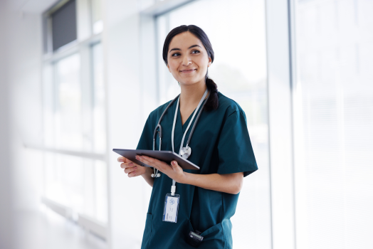Female doctor in hospital  looking at digital tablet